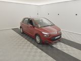 the small red car is parked in the garage on the checkered floor