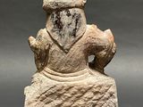 an old stone statue of a man with a hat on his head