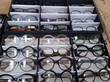 many pairs of glasses sitting in a box on the floor