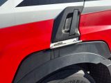 a close up of a red and white truck with a door handle