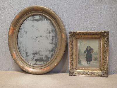 a mirror and a picture frame sitting on a shelf