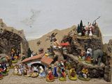 many figurines of people in a nativity setting