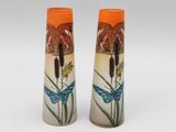 two vases that are sitting on a white surface