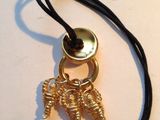 a gold plated keychain with a bunch of charms attached to it