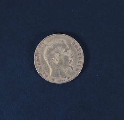 a close up of a silver coin on a blue surface