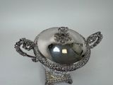 an antique silver plated bowl with a handle and handles