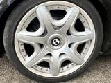 the wheel of a car with a flat tire is shown