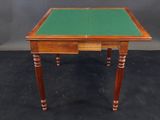 a small table with a green top and wooden legs
