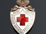 an image of a badge with a red cross on it