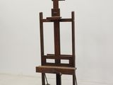 a wooden easel with a wooden seat on it