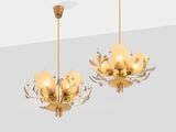 a pair of chandeliers in the style of chandeliers