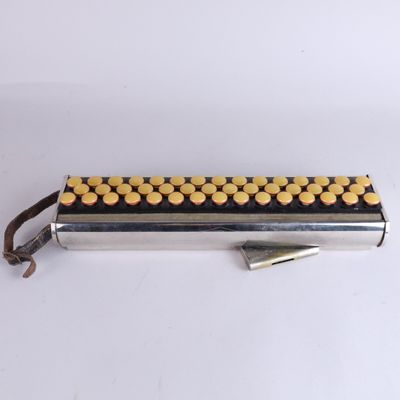 a close up of a metal object with yellow dots on it