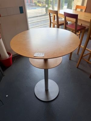 a table and chairs in a room with a large window