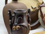 three vases and a plate on the table