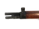 a close up of a rifle on a white surface with a white background