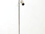 a metal floor lamp with two lights on top of it
