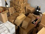 many boxes and bottles of wine sitting on the floor