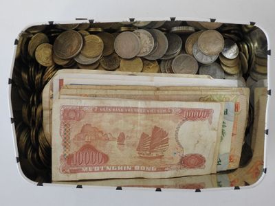 a box full of money and coins on the table