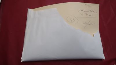 someone wrote a note on a piece of paper on a red surface