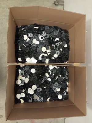 a cardboard box filled with lots of black and white sequins