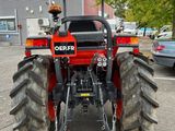 a red tractor that is parked in a parking lot