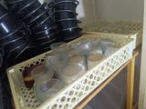 many pots and pans sitting on a shelf in the kitchen