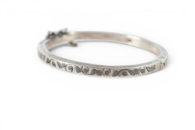 a close up of a silver ring on a white surface