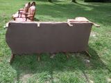 a couch that is sitting on the grass in the yard