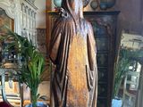 a statue of a woman standing on a table in a room