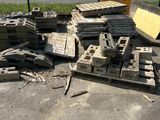 a pile of bricks sitting on the ground next to a fence