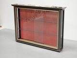 a picture of a display case with a red glass door