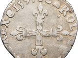 an old silver coin with a cross on it
