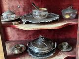a shelf that has a lot of silver items on it