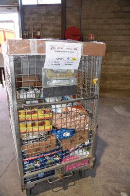 a cart full of food in a building with a sign on it