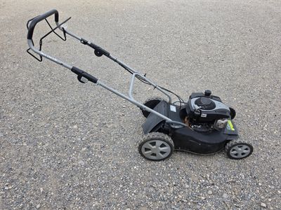 an image of a lawn mower sitting on the ground