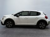 the white car is parked on the concrete floor in the room