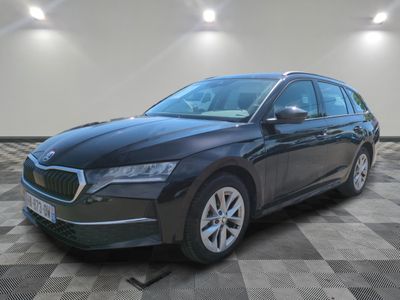 a black car is parked on a checkered floor in a garage