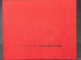 a red book with the title john hunter getting there written on it