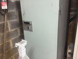 an old refrigerator in the corner of a room