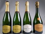 three bottles of champagne sitting next to each other on a table