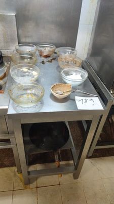 many bowls and pans on the table in the kitchen