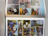 a picture of a comic book open on a table