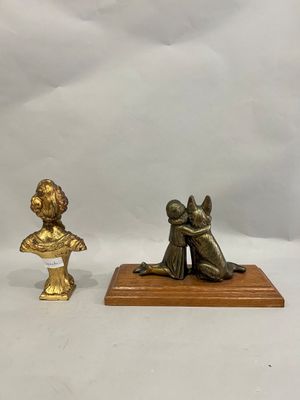 two bronze figurines of a woman and a child on a wooden base