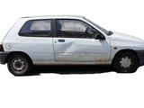 a white car that is parked on the side of the road