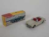 dinky model of a car with a box on a white surface