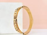 a gold ring sitting on top of a marble block