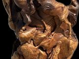 statue of a group of horses on a rock with a black background