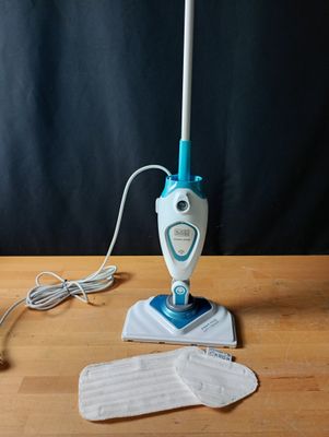 a mop that is sitting on a table next to a pair of gloves