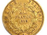 a close up of a gold coin on a white surface
