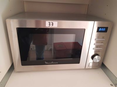 a microwave that is sitting on a counter in a kitchen